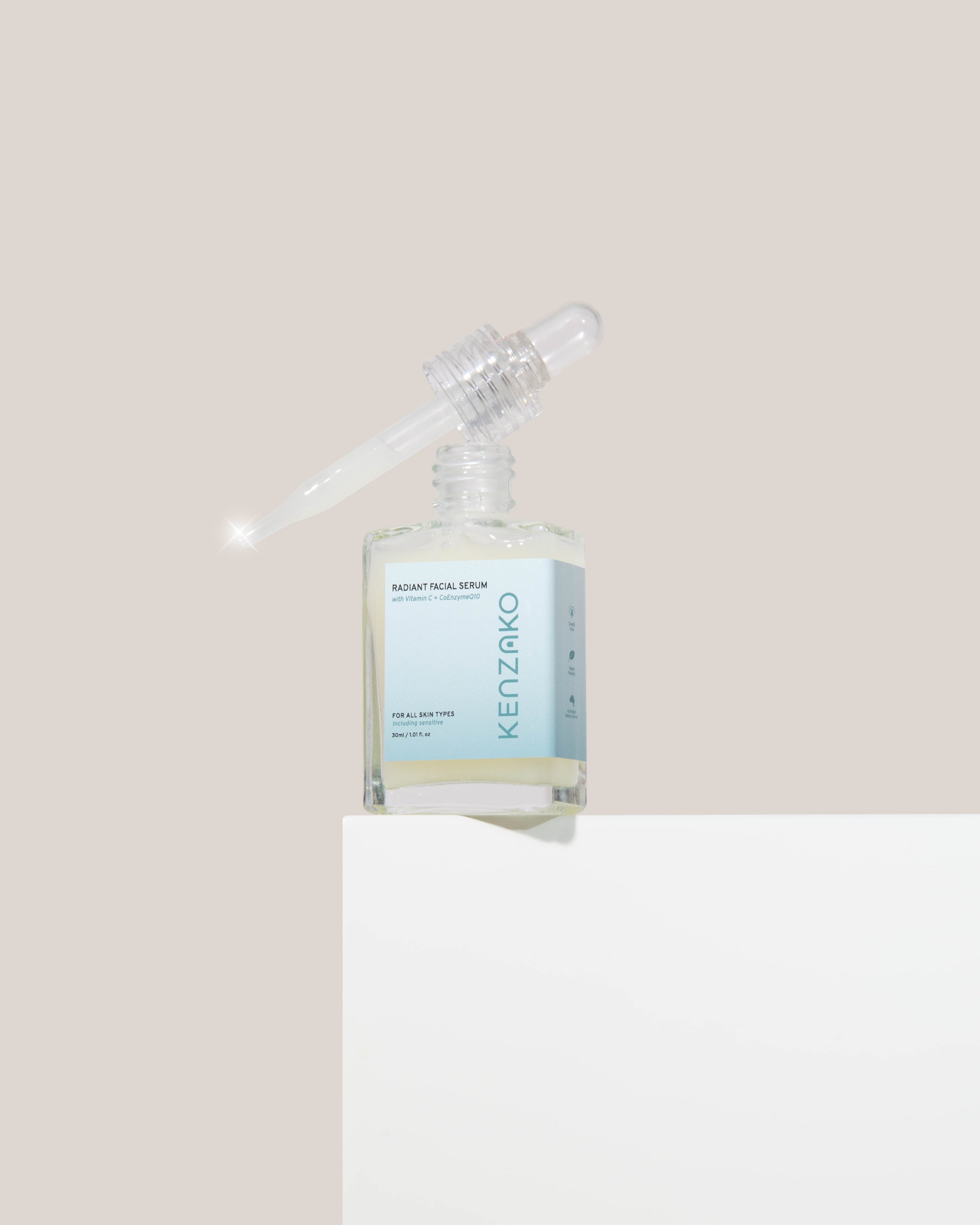 Radiant Face Serum - Vitamin C Peptides &amp; CoQ10 bottle displayed with dropper against a neutral background.